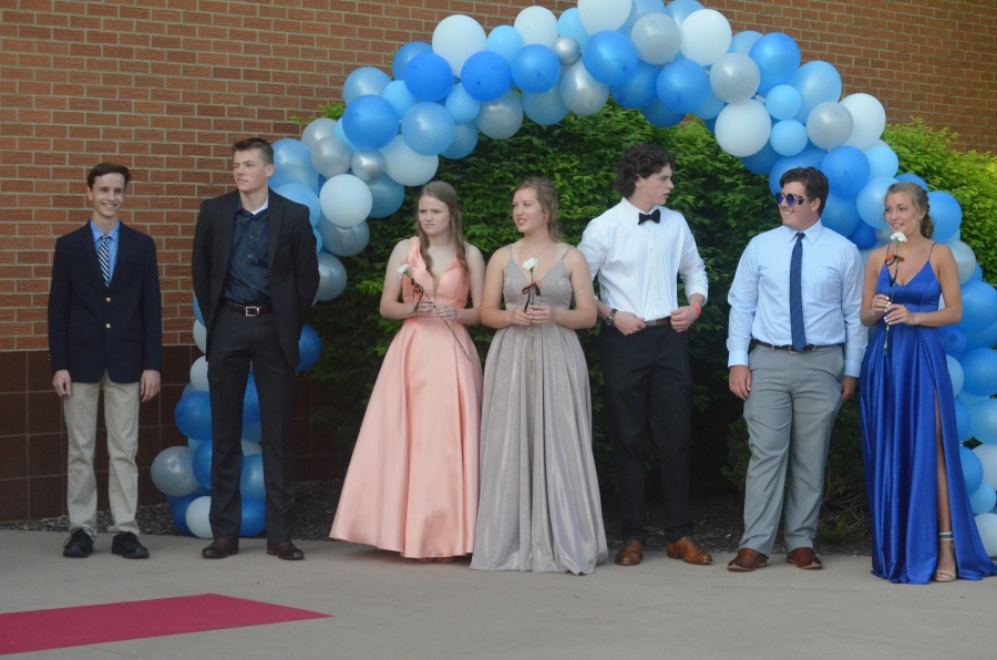 many people under a balloon arch